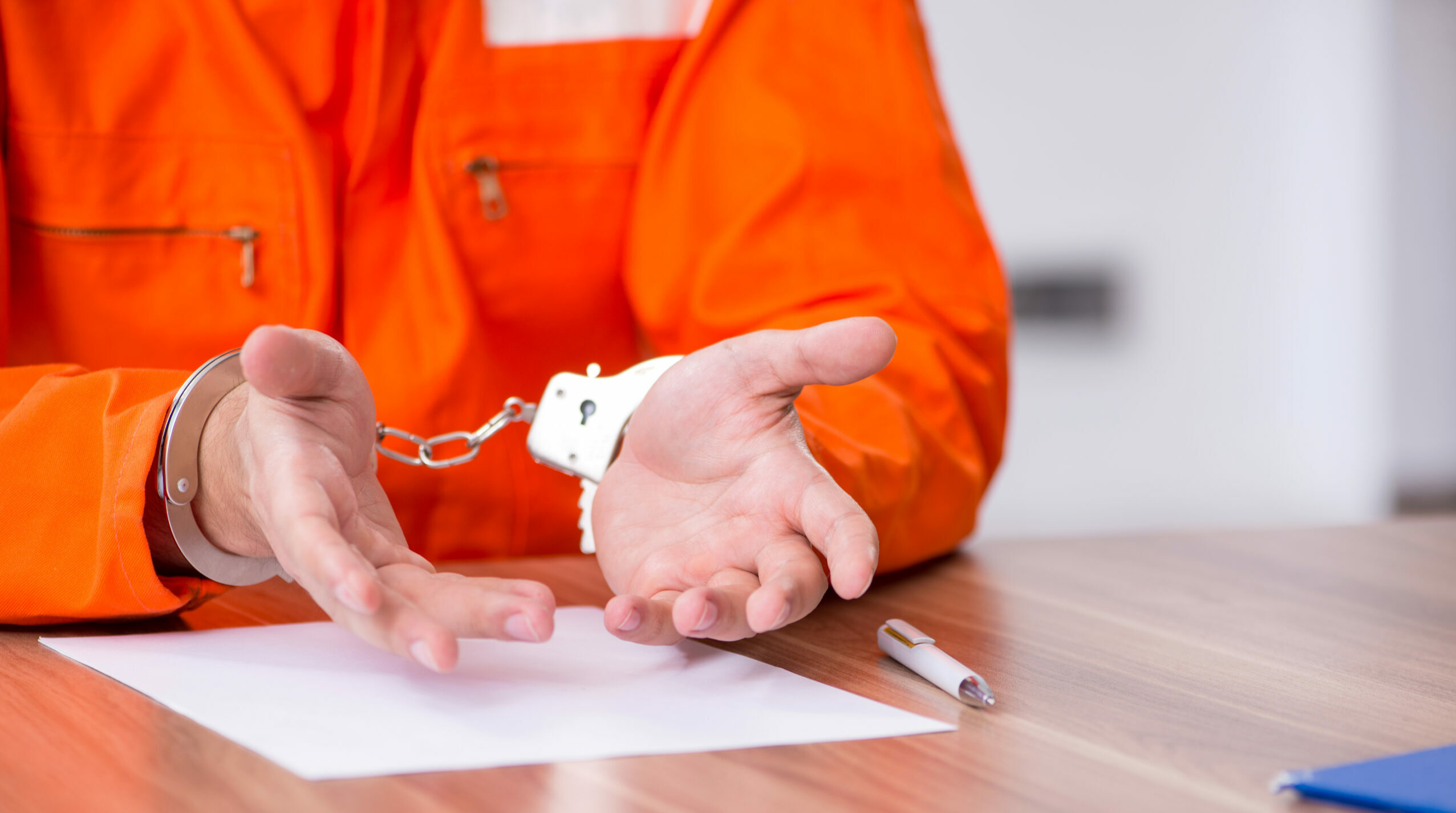 Young man writing letter in provisional detention